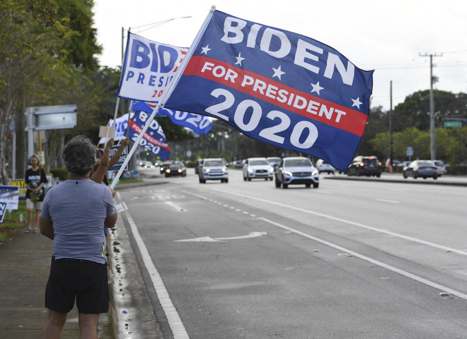 CORAL SPRINGS, FL - OCTOBER 31: People seen campaigning during in person early voting at the Northwest Regional Library during the 2020 Presidential Election on October 31, 2020 in Coral Springs, Florida. Credit: mpi04/MediaPunch /IPX