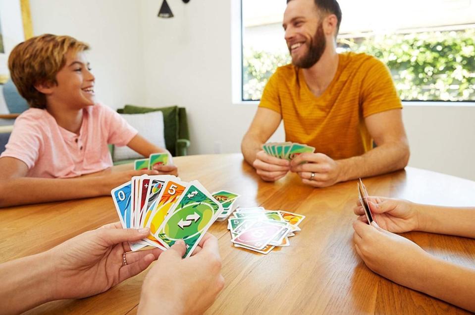 group of people playing Uno card game together