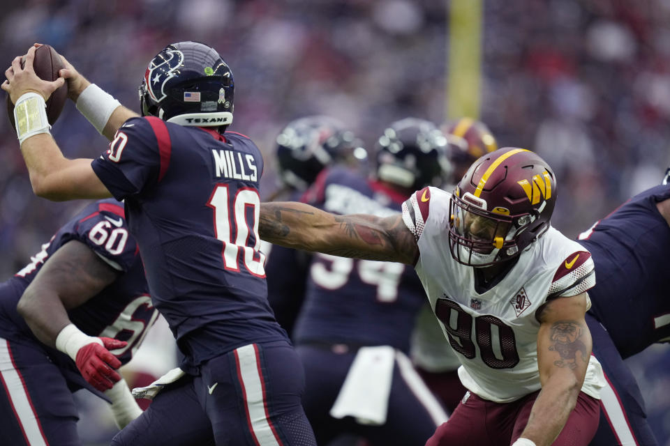 Houston Texans quarterback Davis Mills (10) is pressured by Washington Commanders defensive end Montez Sweat (90) during the second half of an NFL football game Sunday, Nov. 20, 2022, in Houston. (AP Photo/Eric Christian Smith)