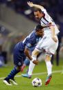 Porto's Alex Sandro Lobo (L) fights for the ball with FC Basel's Marco Streller during their Champions League round of 16 second leg soccer match at Dragao stadium in Porto, March 10, 2015. REUTERS/Miguel Vidal (PORTUGAL - Tags: SPORT SOCCER)