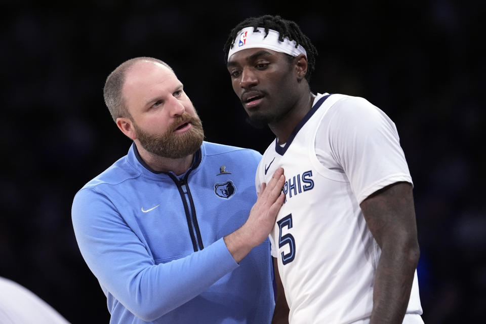 Memphis Grizzlies head coach Taylor Jenkins talks to guard Vince Williams Jr. (5) during the first half of an NBA basketball game against the New York Knicks, Tuesday, Feb. 6, 2024, at Madison Square Garden in New York. (AP Photo/Mary Altaffer)