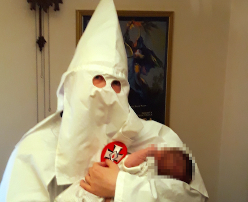 A picture shown to jurors showing Thomas posing with his newborn baby while wearing Ku Klux Klan robes (Picture: PA)