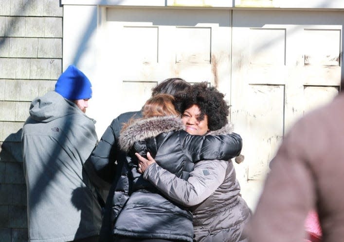 Charity-Grace Mofsen, right, who was associate director of operations at the African Meeting House at the time, gets a hug after Nantucket community members showed up to scrub racist graffiti from the front of the building in 2018.