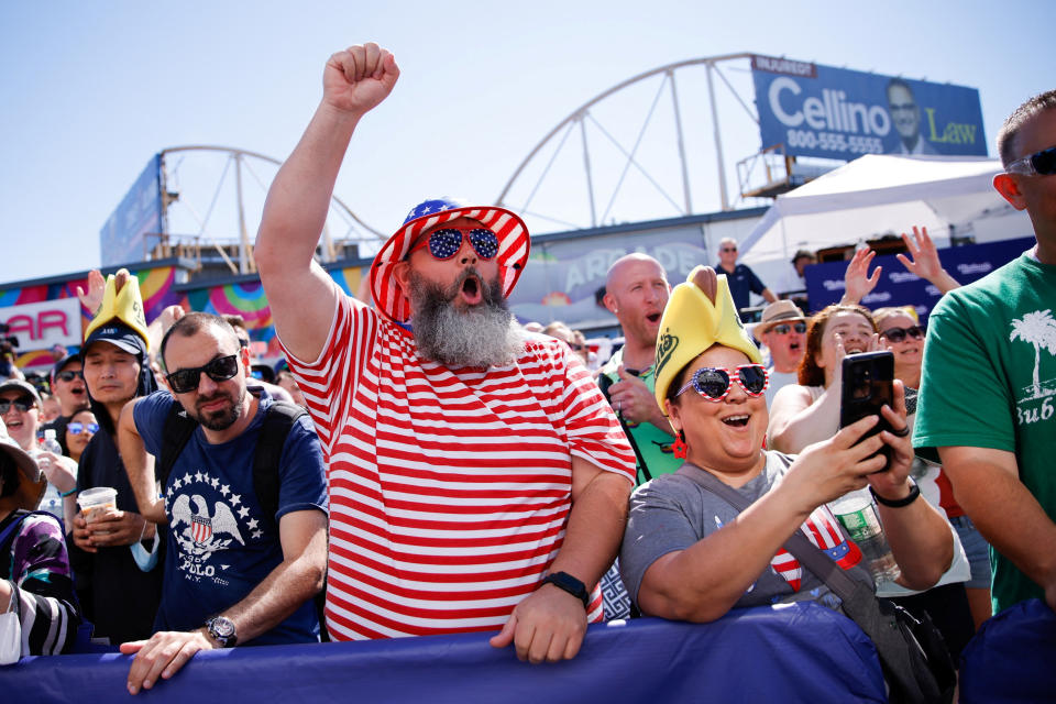 People attend Nathan’s Famous Fourth of July International Hot Dog Eating Contest as it returns to the flagship restaurant after the easing of COVID-19 restrictions, at Coney Island in New York, U.S., July 4, 2022. REUTERS/Eduardo Munoz