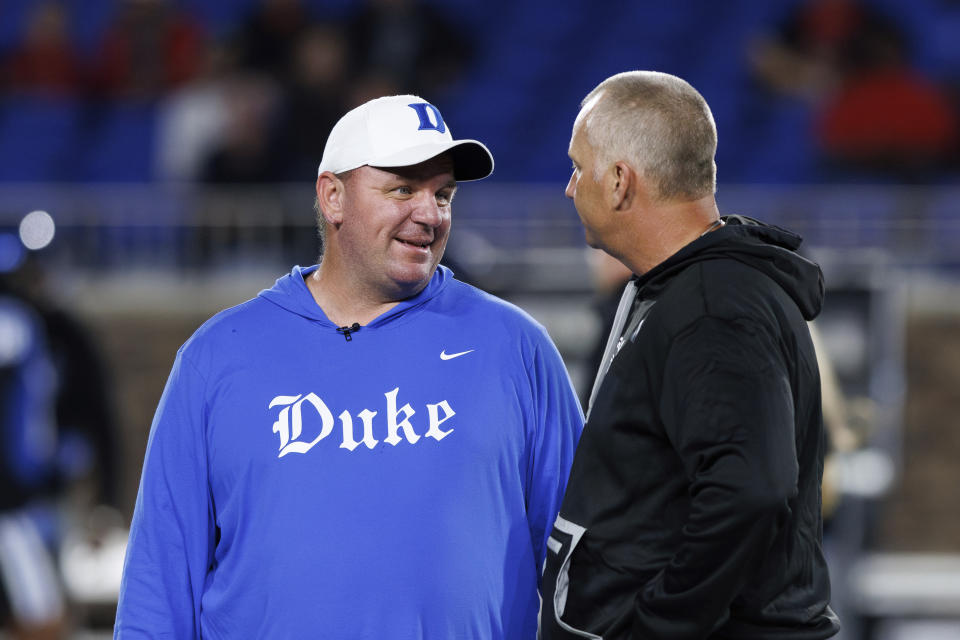 Duke head coach Mike Elko, left, speaks with North Carolina State head coach Dave Doeren, right, prior to an NCAA college football game in Durham, N.C., Saturday, Oct. 14, 2023. (AP Photo/Ben McKeown)