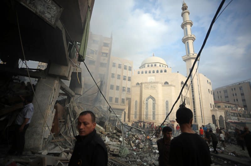 Palestinians inspect the destruction following Israeli airstrikes on a market in residential neighborhood in Khan Younis, southern Gaza Strip on Tuesday. Photo by Ismael Mohamad/UPI