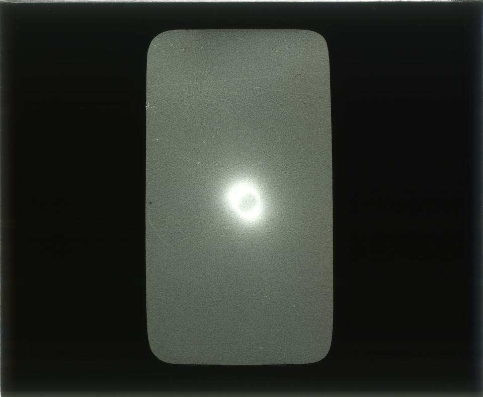 A black and white glass plate negative of the 1918 total eclipse taken by Ed Tangen, a photographer from Boulder.