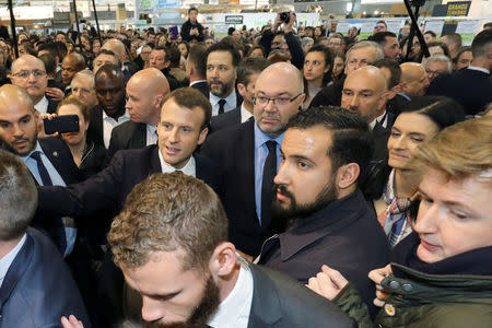 French President Emmanuel Macron, French Agriculture Minister Stephane Travert and Elysee senior security officer Alexandre Benalla visit the 55th International Agriculture Fair (Salon de l'Agriculture) at the Porte de Versailles exhibition center in Paris, France, February 24, 2018. Ludovic Marin/Pool via Reuters