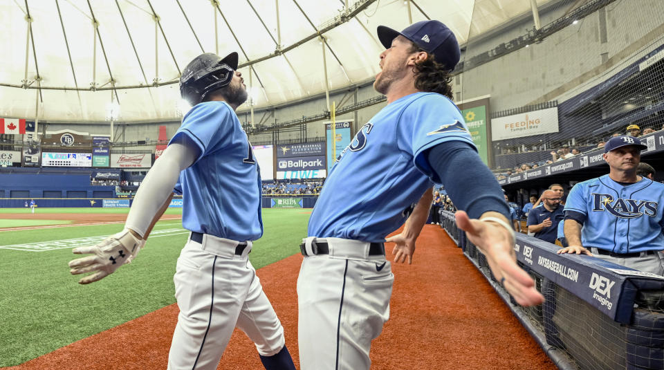 Tampa Bay Rays' Brett Phillips celebrates with Brandon Lowe, left, after Lowe's solo home run off Toronto Blue Jays starter Ross Stripling during the first inning of a baseball game Saturday, July 10, 2021, in St. Petersburg, Fla. (AP Photo/Steve Nesius)