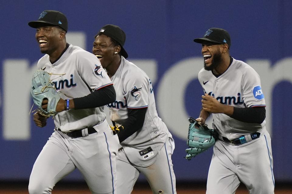 Miami Marlins' Jesus Sanchez, left, Jazz Chisholm Jr., center, and Bryan De La Cruz smile after the second baseball game of a doubleheader against the New York Mets, Wednesday, Sept. 27, 2023, in New York. (AP Photo/Frank Franklin II)