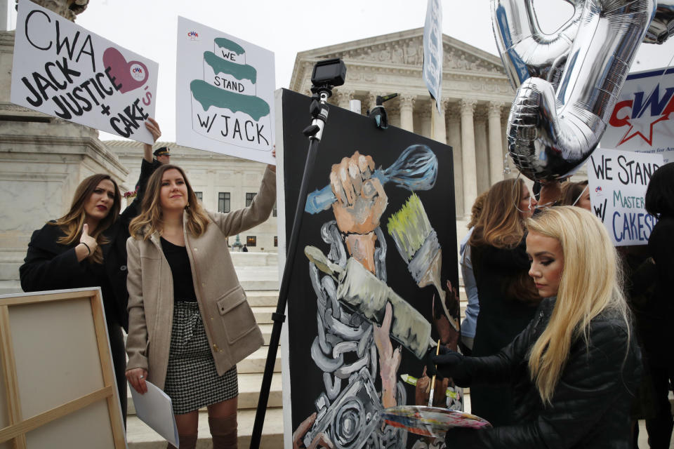 <p>As Janae Stracke, left, and Annabelle Rutledge, both with Concerned Women for America, hold up signs, as Jessica Haas, of Indianapolis, paints during a rally with supporters of cake artist Jack Phillips outside of the Supreme Court which is hearing the ‘Masterpiece Cakeshop v. Colorado Civil Rights Commission’ today, Tuesday, Dec. 5, 2017, in Washington. (Photo: Jacquelyn Martin/AP) </p>