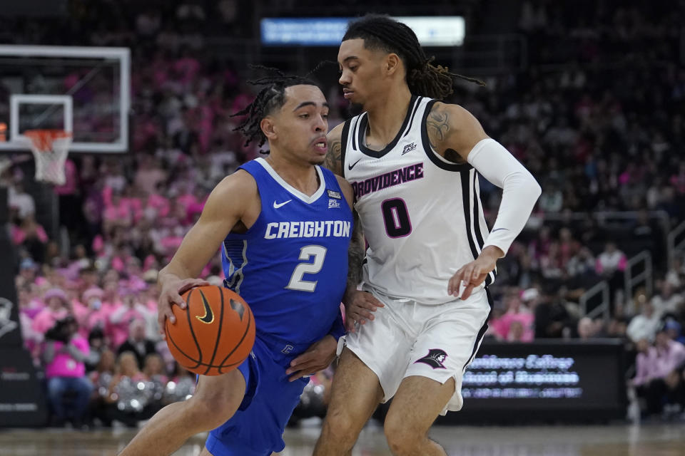Creighton guard Ryan Nembhard (2) drives toward the basket as Providence guard Alyn Breed (0) defends in the first half of an NCAA basketball game, Tuesday, Feb. 14, 2023, in Providence, R.I. (AP Photo/Steven Senne)