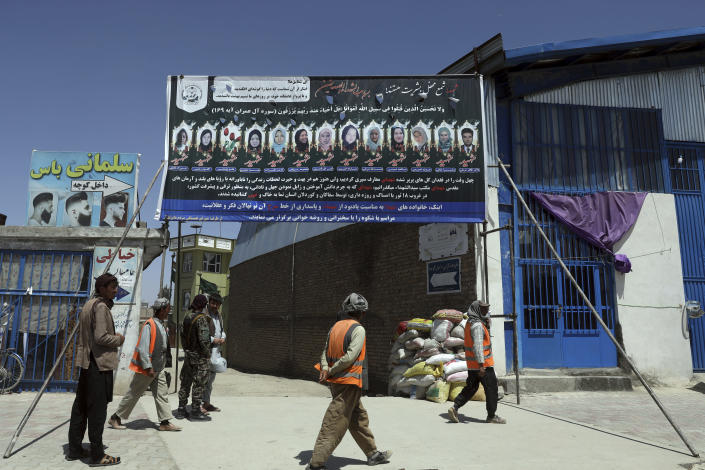 Photographs of killed students of Syed Al-Shahada School are displayed on the gate of a mosque in Dasht-e-Barchi neighborhood of Kabul, Afghanistan, Tuesday, June 1, 2021. After the collapse of the Taliban 20 years ago, Afghanistan's ethnic Hazaras began to flourish and soon advanced in various fields, including education and sports, and moved up the ladder of success. They now fear those gains will be lost to chaos and war after the final withdrawal of American and NATO troops from Afghanistan this summer. (AP Photo/Rahmat Gul)