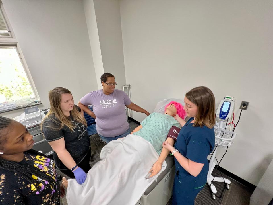 Jada Moton, Megan Wilson, Keashli McDaniel and Heather Gibson practice in the medical assisting classroom at Cleveland Community College.
