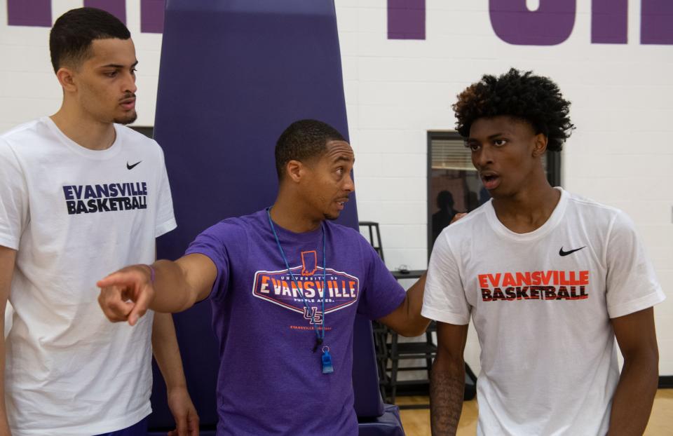 Head Coach David Ragland, left, gives instructions to Zaveion Chism-Okoh, right, during an exercise at the first UE Men's Basketball summer practice at Fifth Third Bank Practice Facility in Evansville, Ind., Tuesday, June 21, 2022.