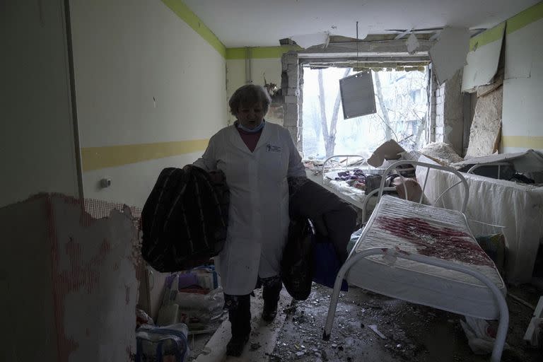 A medical worker walks inside of the damaged by shelling maternity hospital in Mariupol, Ukraine, Wednesday, March 9, 2022. A Russian attack has severely damaged a maternity hospital in the besieged port city of Mariupol, Ukrainian officials say. (AP Photo/Evgeniy Maloletka)