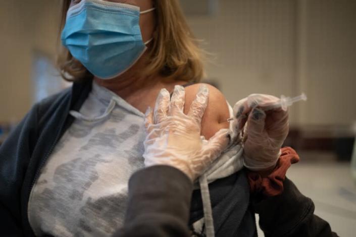 A resident receives a Covid-19 booster shot at a vaccine clinic inside Trinity Evangelic Lutheran Church in Lansdale, Pennsylvania, U.S, on Tuesday, Apr. 5, 2022. U.S. regulators cleared second booster doses of Covid-19 vaccine from Moderna Inc. and the partnership of Pfizer Inc. and BioNTech SE for adults 50 and older, making millions more people eligible for the shots as concern grows about a potential new wave of infections. Photographer: Hannah Beier/Bloomberg via Getty Images