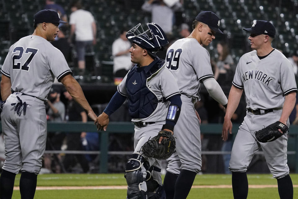 New York Yankees' Giancarlo Stanton, left, catcher Jose Trevino, Aaron Judge, second from right, and relief pitcher Chad Green celebrate the team's 15-7 win over the Chicago White Sox in a baseball game in Chicago, Thursday, May 12, 2022. (AP Photo/Nam Y. Huh)