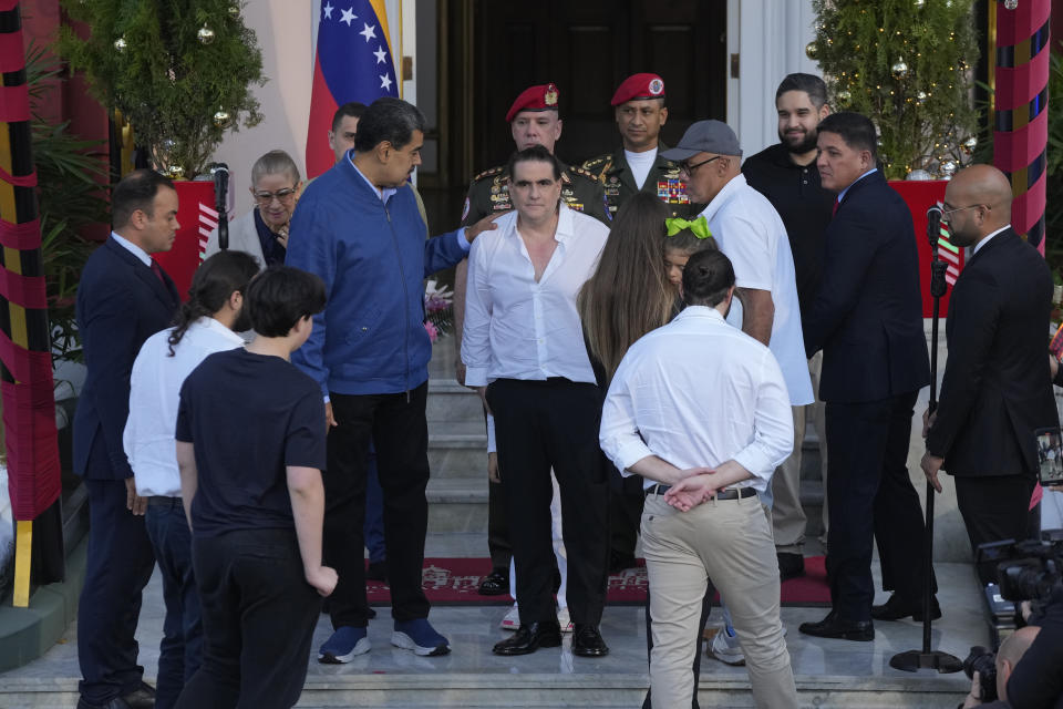 Venezuelan President Maduro, center left, places his hand on Alex Saab's shoulder as he receives Saab at Miraflores presidential palace in Caracas, Venezuela, Wednesday, Dec. 20, 2023. The United States freed Saab, who was arrested on a U.S. warrant for money laundering in 2020, in exchange for the release of 10 Americans imprisoned in Venezuela, U.S. officials said Wednesday. (AP Photo/Matias Delacroix)