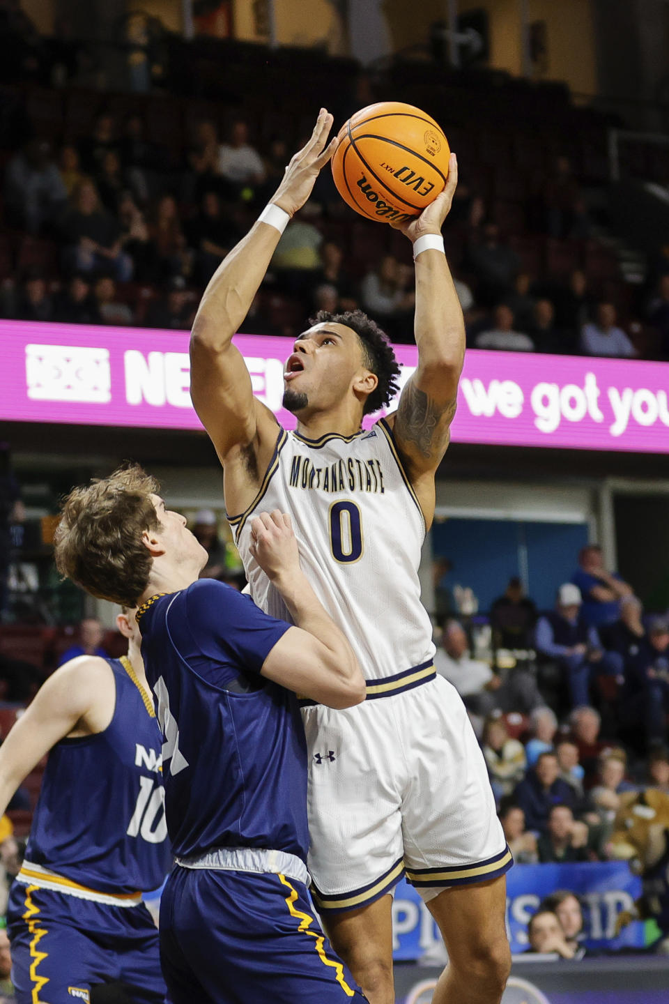 Montana State guard Caleb Fuller (0) goes to the basket against a Northern Arizona defender in the first half of an NCAA college basketball game for the championship of the Big Sky men's tournament in Boise, Idaho, Wednesday, March 8, 2023. (AP Photo/Steve Conner)