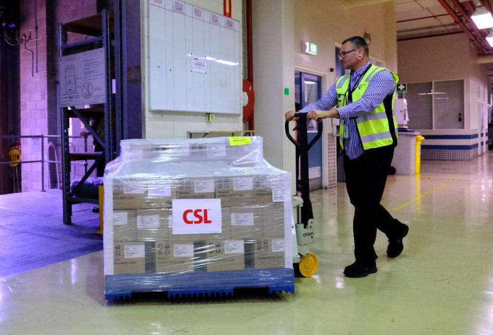 A worker at CSL rolls out the first batch of the AstraZeneca vaccine in Melbourne, Australia, onto a truck. 