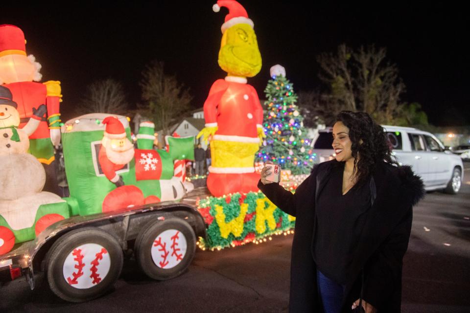Organizer Fina Vasquez takes video of the Weston Ranch Holiday Parade, which ran from Weston Ranch High School to August Knodt in the Weston Ranch neighborhood of Stockton on the evening of Friday, Dec. 16, 2022. This is the second year for the parade thought up by August Knodt Elementary School employee Fina Vasquez who also coordinated this year's event. "The community has been so wonderful to my family and me," said Vasquez. "I just want to give back to the community." The parade, which went from Weston Ranch High School to August Knodt Elementary School,  featured more than 20 floats and vehicles representing area schools, clubs and individuals and the Weston Ranch High School band as well as guests of honor, Mayor Kevin Lincoln, and Manteca Unified School District board president Marie Freitas. Grand marshals were MUSD board trustee Eric Duncan and Stockton Councilwoman Kimberly Warmsley.