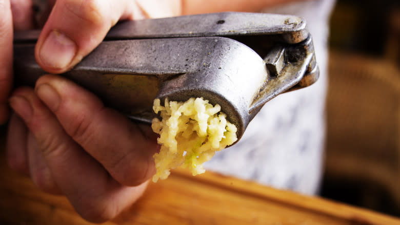 garlic being pressed