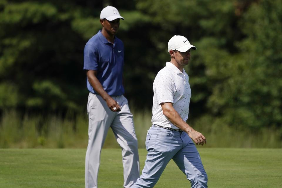Rory McIlroy, right, and Tiger Woods walk on the thirteenth fairway during the third round of the Northern Trust golf tournament at TPC Boston, Saturday, Aug. 22, 2020, in Norton, Mass. (AP Photo/Charles Krupa)