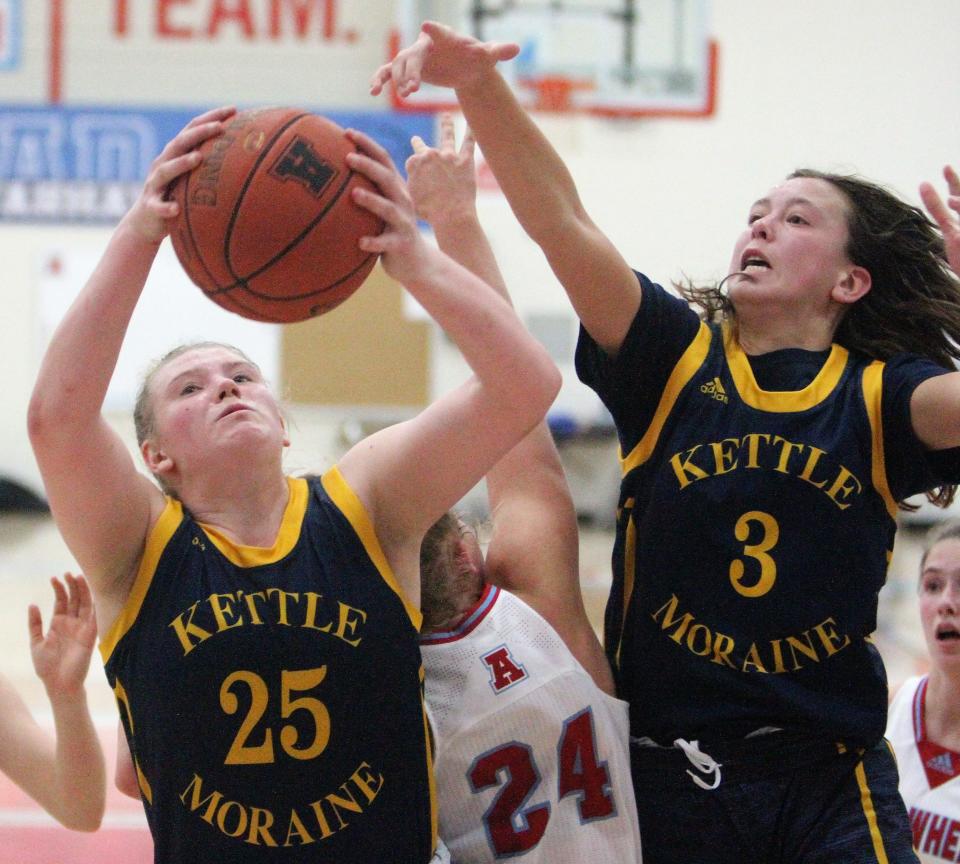 Kettle Moraine forward Grace Grocholski grabs a rebound in front of teammate Lily Randgaard during a Dec. 14 game. The Lasers are the No. 2 ranked team in Division 1.