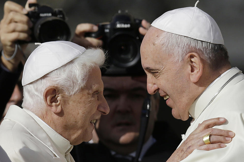 FILE - Pope Francis, right, hugs Emeritus Pope Benedict XVI prior to the start of a meeting with elderly faithful in St. Peter's Square at the Vatican on Sept. 28, 2014. Pope Francis has exposed the political “maneuvers” to sway votes during the past two conclaves and denied he is planning to reform the process to elect a pope in a new book-length interview published Tuesday April 2, 2024. (AP Photo/Gregorio Borgia, File)