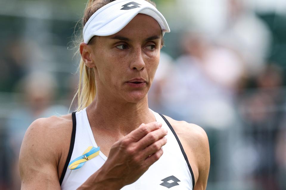 Lesia Tsurenko, pictured here wearing a blue and yellow ribbon for Ukraine at Wimbledon.