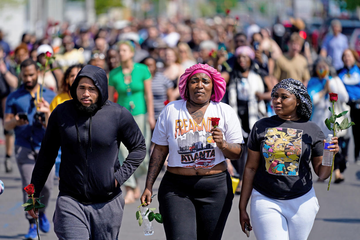 People march to the scene of the shooting at a Tops Friendly Market (Matt Rourke / AP)
