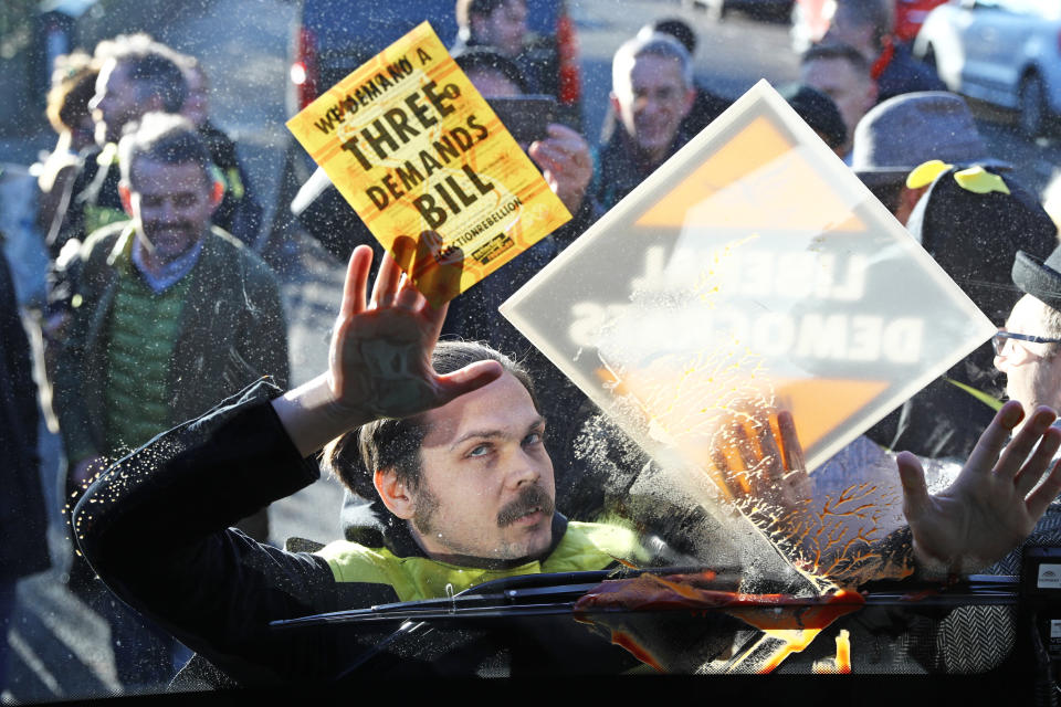 Extinction Rebellion protesters dressed as bees glue themselves to Liberal Democrat Leader Jo Swinson's battle bus during a visit to Knights Youth Centre in London, while on the General Election campaign trail.