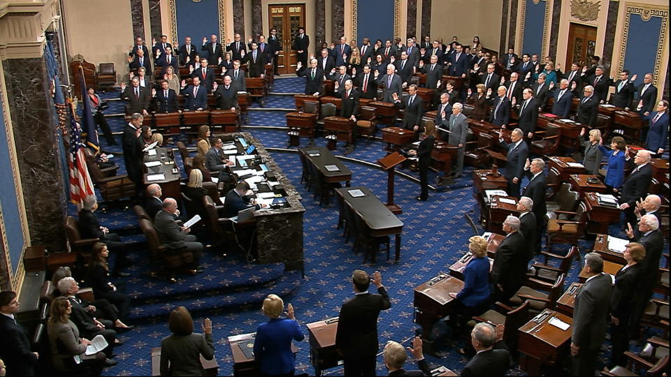 Chief Justice John Roberts swears in members of the Senate for the impeachment trial against President Trump at the U.S. Capitol in Washington, D.C., Thursday. (Senate Television via AP)