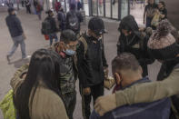 Benjamin Villalta prays with fellow Nicaraguan migrants who walked together in a recent caravan headed to the U.S. border, before traveling to the city of Mexicali from Monterrey, Nuevo Leon state, Mexico, Nov. 29, 2021, after obtaining humanitarian visas allowing them to move about Mexico and work. (AP Photo/Felix Marquez)