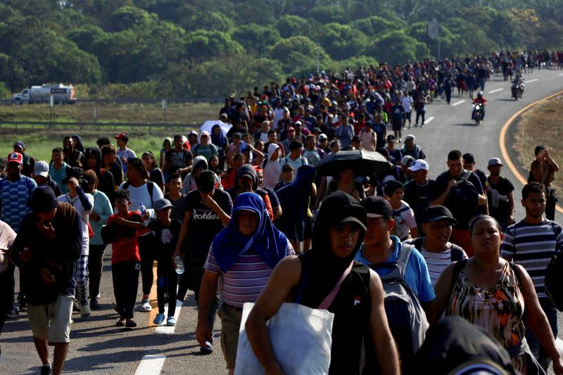 Migrants walk in a caravan to reach the U.S. border through Mexico, in Huixtla