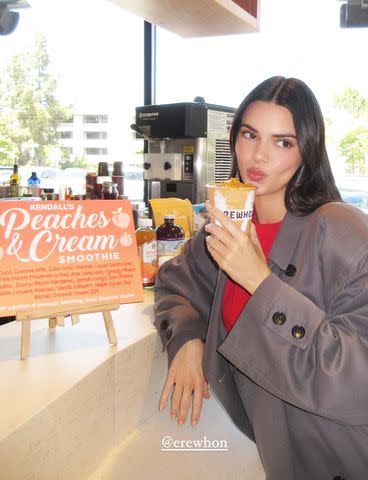 <p>Kendall Jenner/Instagram</p> Kendall Jenner sips on her Peaches & Cream Erewhon Smoothie in May