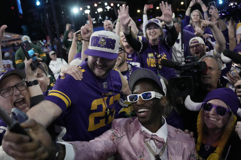 Southern California wide receiver Jordan Addison celebrates with fans after being chosen by the Minnesota Vikings with the 23rd overall pick during the first round of the NFL football draft, Thursday, April 27, 2023, in Kansas City, Mo. (AP Photo/Charlie Riedel)