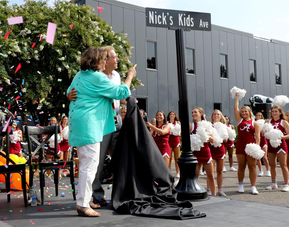 The City of Tuscaloosa renamed 28th Avenue as Nick's Kids Avenue on Aug. 5, 2021. Terry and Nick Saban enjoy the moment after they have unveiled the street sign.