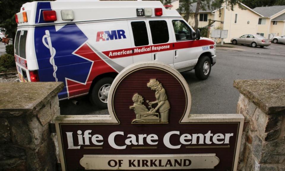 An ambulance transports a person from the Life Care Center of Kirkland, a long-term care facility linked to several confirmed coronavirus cases, in Kirkland, Washington state on Tuesday.