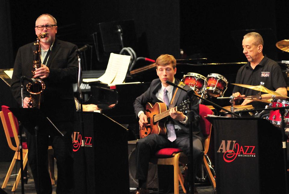 Guest artist Chris Burge, left, on the saxophone and Sammy Deleon, right, on percussion, play with the Ashland University Jazz Orchestra at the Maplerock Jazz Festival Friday, March 17, 2023 at Ashland University’s Hugo Young Theatre. Playing guitar is Grant Vance.