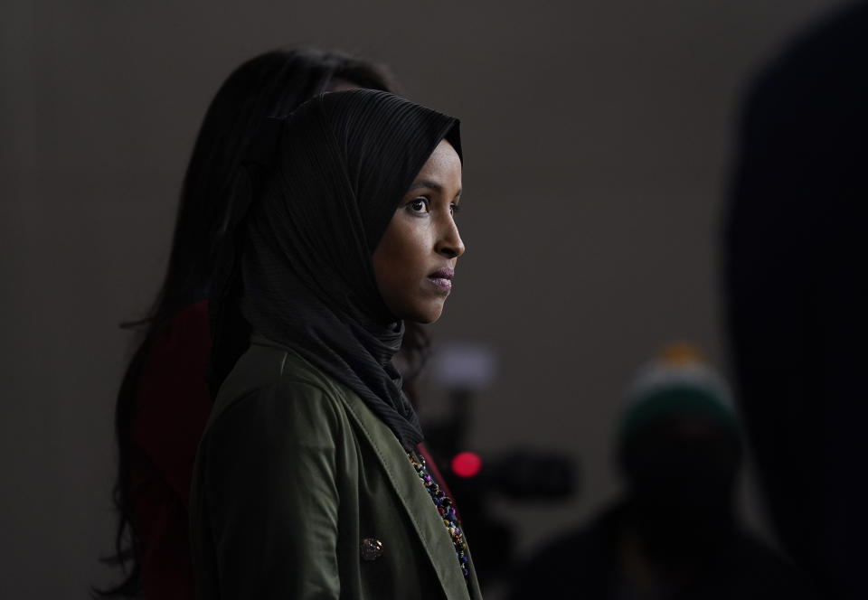 Rep. Ilhan Omar, D-Minn., waits to speak to reporters in the wake of anti-Islamic comments made last week by Rep. Lauren Boebert, R-Colo., who likened Omar to a bomb-carrying terrorist, during a news conference at the Capitol in Washington, Tuesday, Nov. 30, 2021. (AP Photo/J. Scott Applewhite)