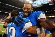 Detroit Lions wide receiver Calvin Johnson (81) celebrates with cornerback Chris Houston (23) after defeating the Dallas Cowboys 31-30 at Ford Field. Mandatory Credit: Andrew Weber-USA TODAY Sports