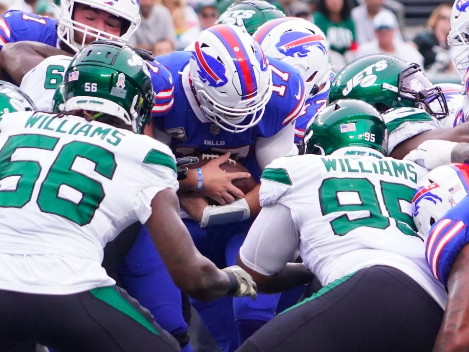 Nov 6, 2022; East Rutherford, NJ, USA; Buffalo Bills quarterback Josh Allen (17) scores a first quarter touchdown on a keeper as the New York Jets are unable to stop him at MetLife Stadium. Mandatory Credit: Robert Deutsch-USA TODAY Sports ORG XMIT: IMAGN-489332 ORIG FILE ID: 20221106_lbm_usa_372.JPG