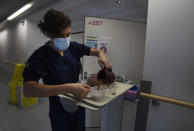 A Belgian Army medic prepares a lunch for a patient with COVID-19 at the St. Michiel Hospital in Brussels, Tuesday, Nov. 24, 2020. The Belgian military has been called into several hospitals and care homes to alleviate the stress on healthcare personnel. (AP Photo/Virginia Mayo)