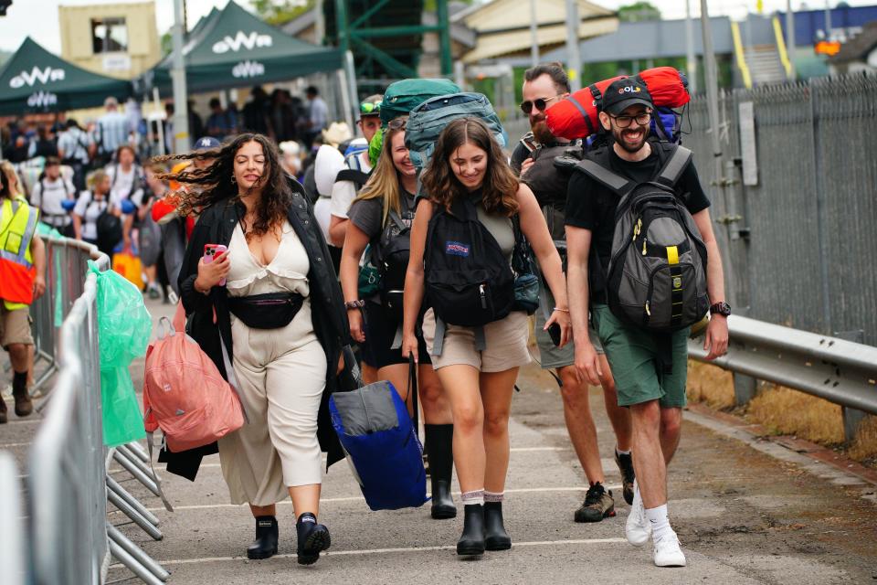 Festivalgoers arrive on the first train service from London into Castle Cary train station as they travel to the site of the Glastonbury Festival at Worthy Farm in Somerset. Picture date: Wednesday June 21, 2023.