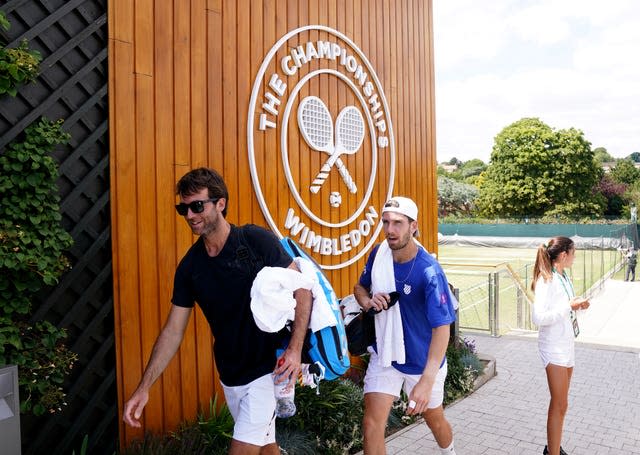 Facunod Lugones (left) and Cameron Norrie walk off the practice courts at Wimbledon 