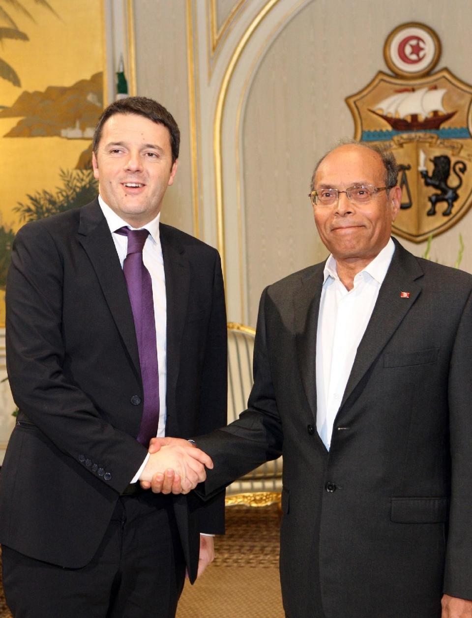 Tunisian President, Moncef Marzouki, right, poses for photographers with Italian Premier, Matteo Renzi , prior to their meeting at the presidential palace in Carthage near Tunis, Tuesday, March 4, 2014. Renzi is in Tunisia for a one-day official visit. (AP Photo/Ali Louati)