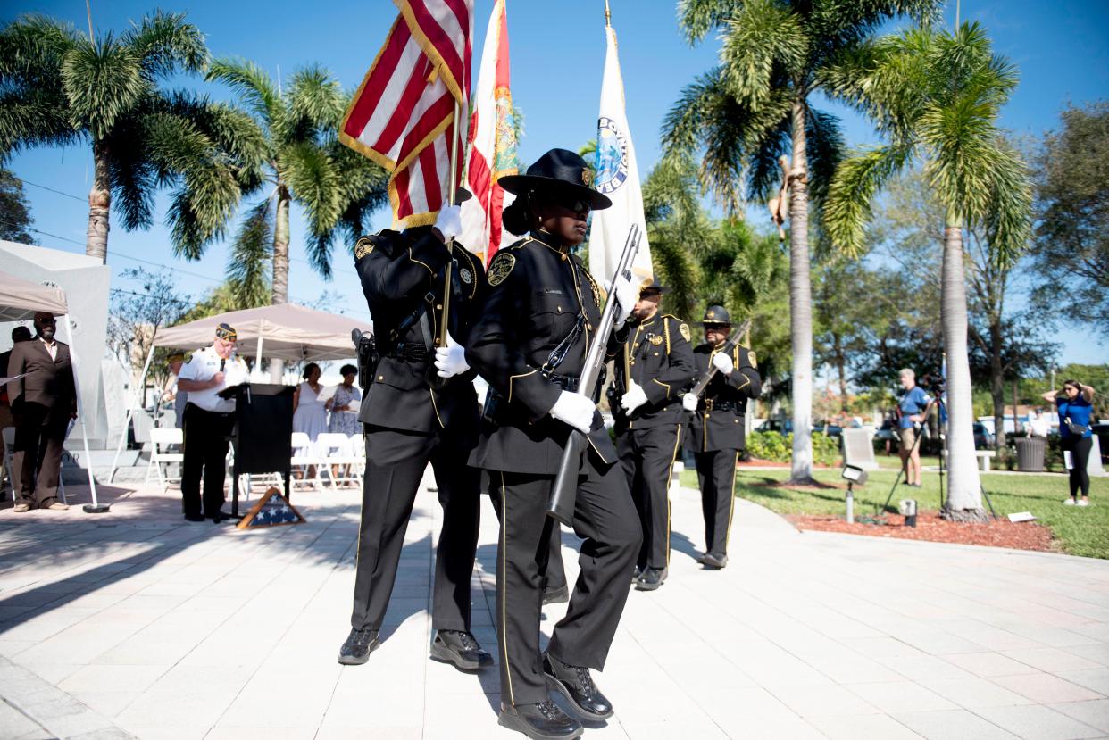 The Boynton Beach police department honor guard advances the colors during the Tuskegee Airmen Monument Dedication Ceremony at at Tom Kaiser, USN, Boynton Beach Veterans Memorial Park February 25, 2023. 