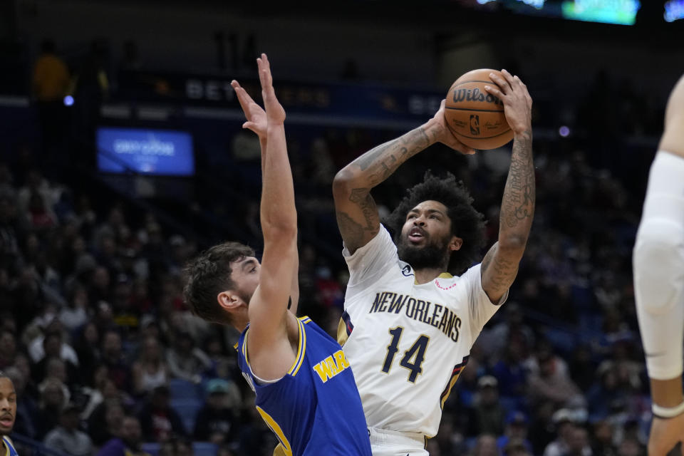 New Orleans Pelicans forward Brandon Ingram (14) shoots against Golden State Warriors guard Ty Jerome in the first half of an NBA basketball game in New Orleans, Monday, Nov. 21, 2022. (AP Photo/Gerald Herbert)
